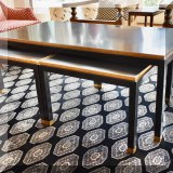 F16. Set of 3 nesting tables. Black with brass trim. 20”h x 55”w x 29”d 